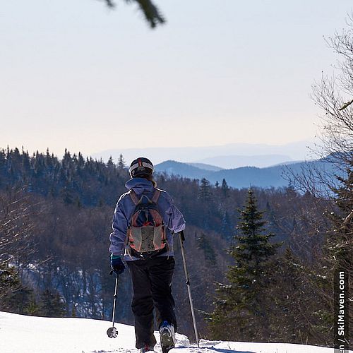 Photo of skier and her tracks through the snow